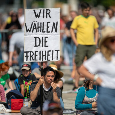 Participants of a Querdenken0711 demonstration, banner with the inscription "We choose freedom".